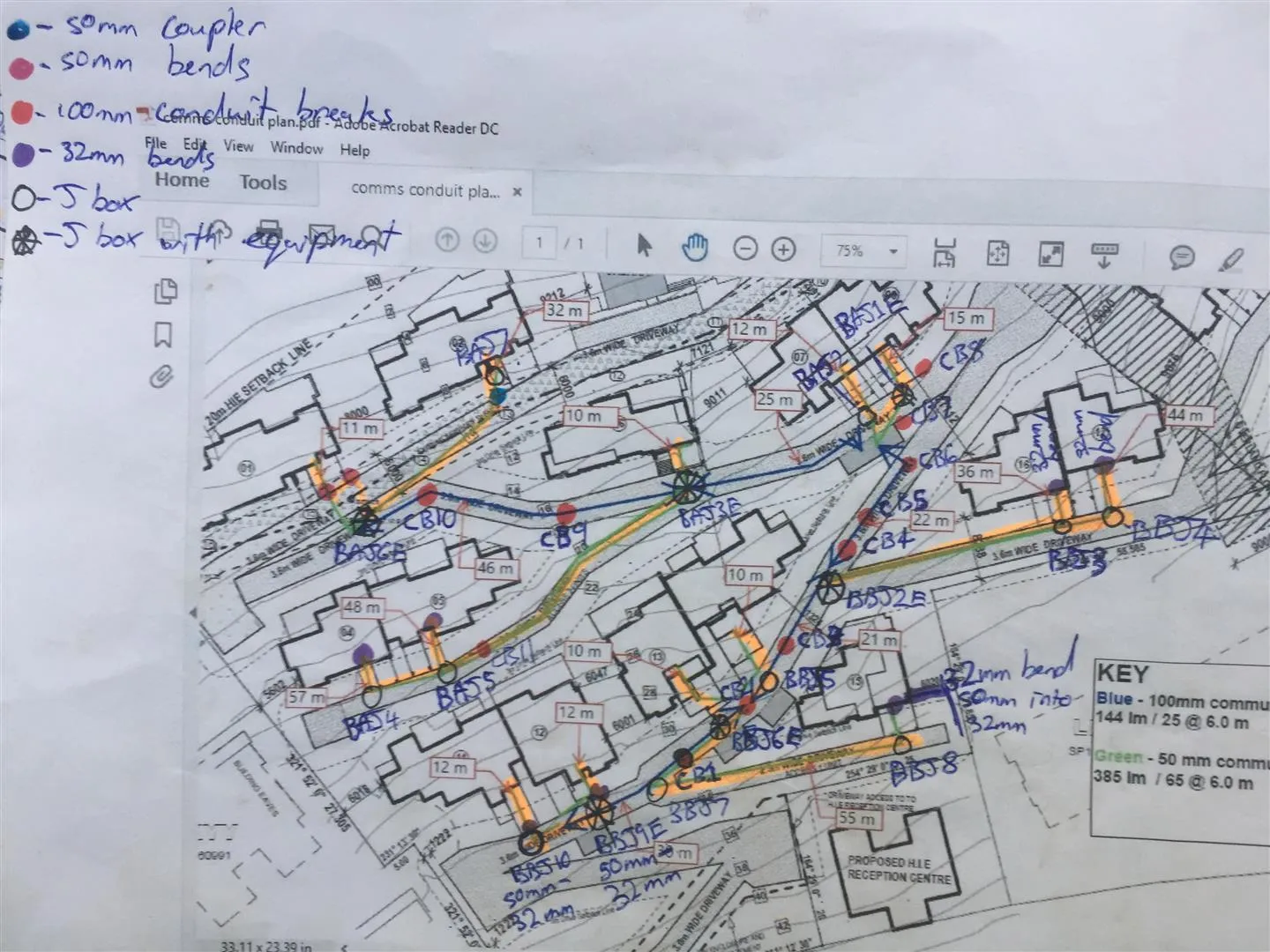 The conduit plan, hand-marked and handed to the builder. Old-school markup of every cable break, coupler, bend, J-box and equipment housing across all 22 properties — colour-coded, key in the margin, ready for the builder to set out.