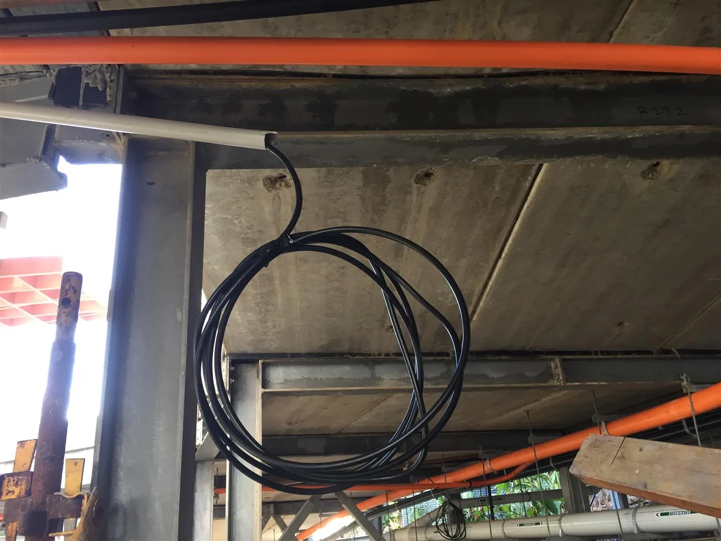 One of 22 — Matchmaster quadshield coiled and ready for fit-off. RG11 backbone and RG6 distribution coaxial waiting at the unit-level termination point for final fit-off and Foxtel certification.