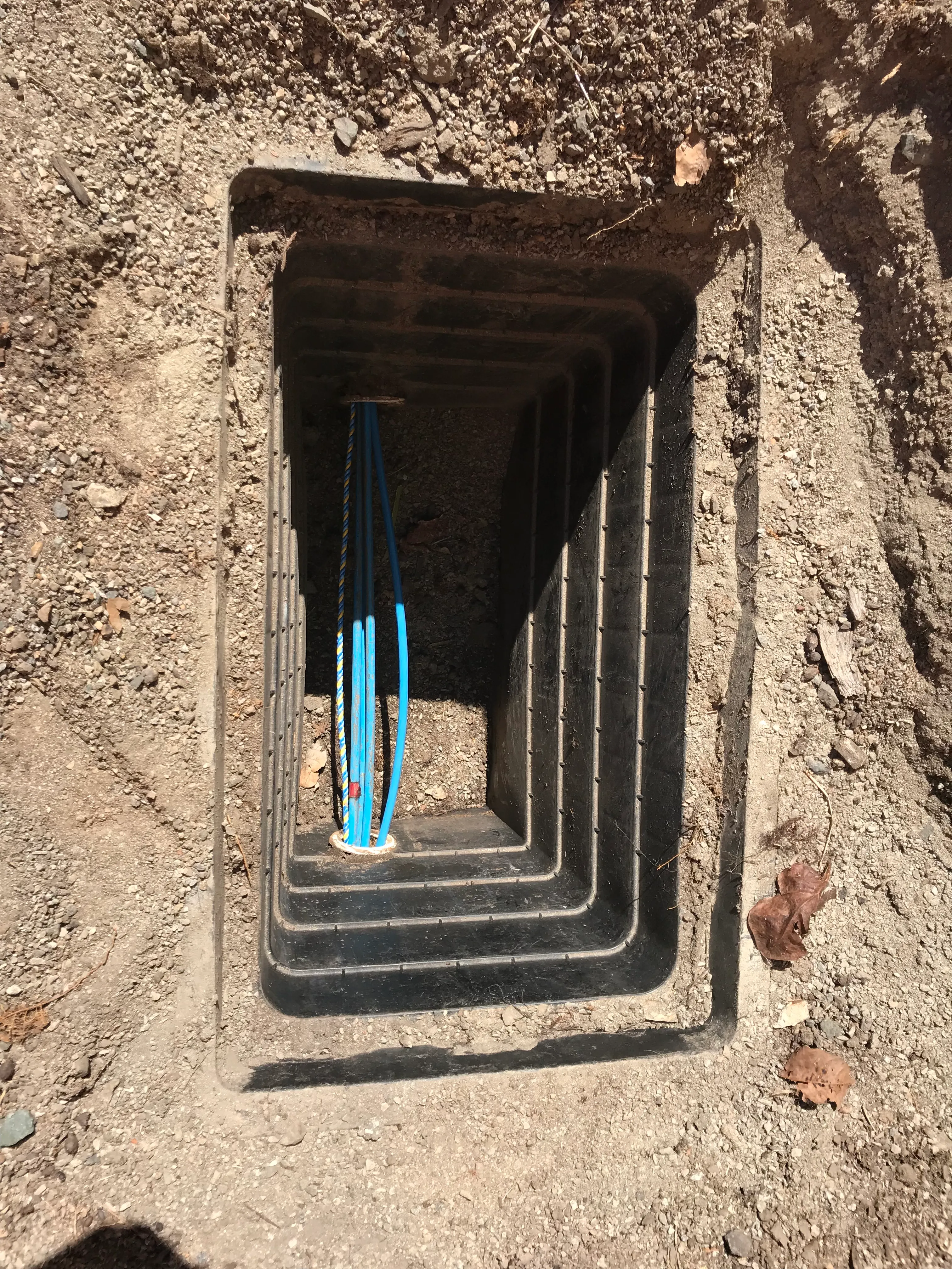Twin 24-core fibre optic sheaths in a cleared pit — Whitsunday Regional Council fibre backbone, Proserpine Main Street